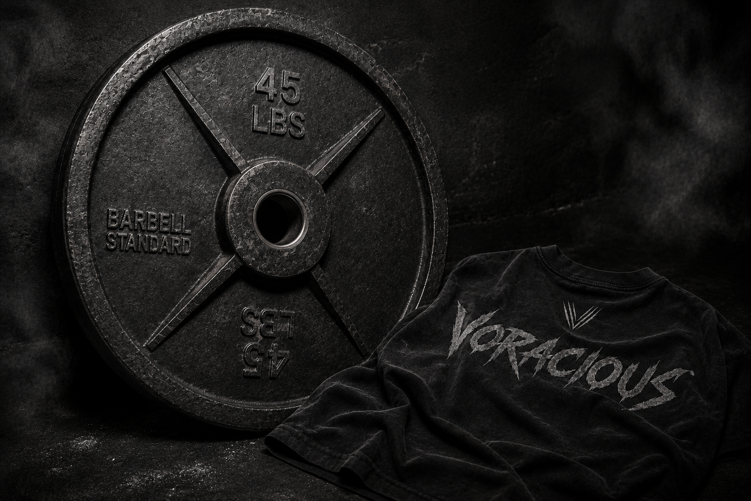 Black VORACIOUS shirt beside a 45lb barbell plate